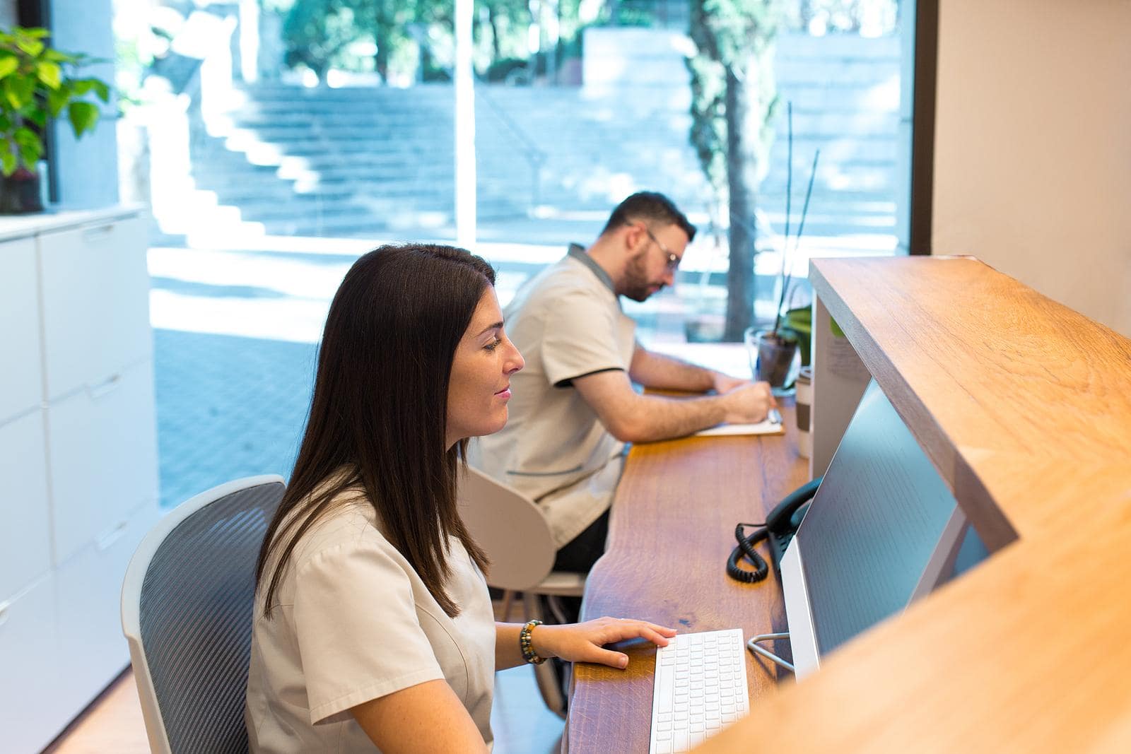 Chiropractic staff working together in a positive office environment, reflecting appreciation and strong team morale.