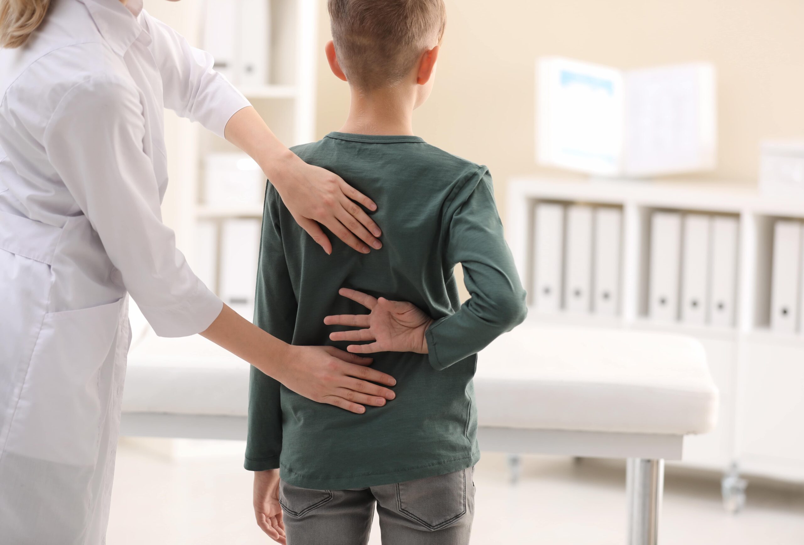 Chiropractor examining child.