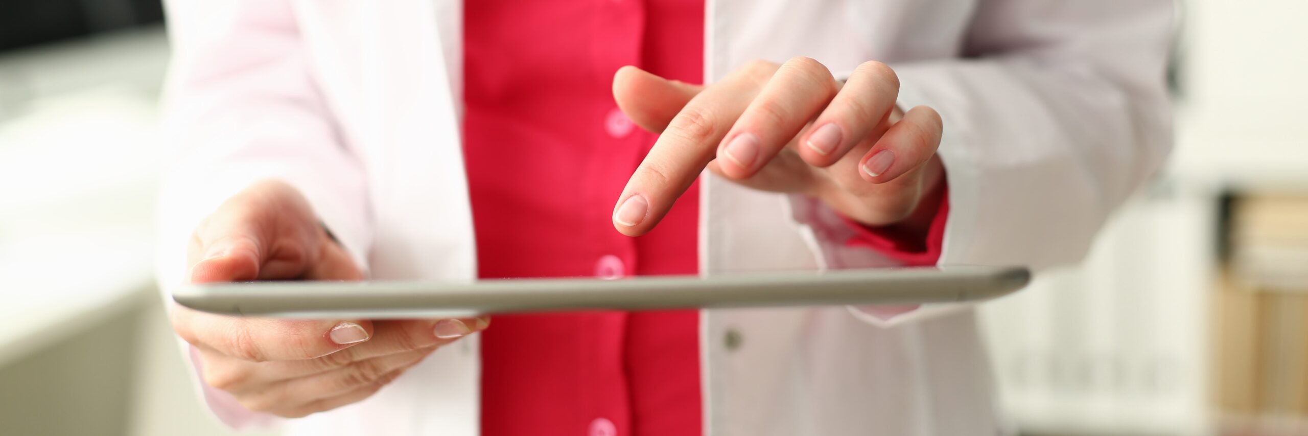 Female chiropractor holding a tablet.