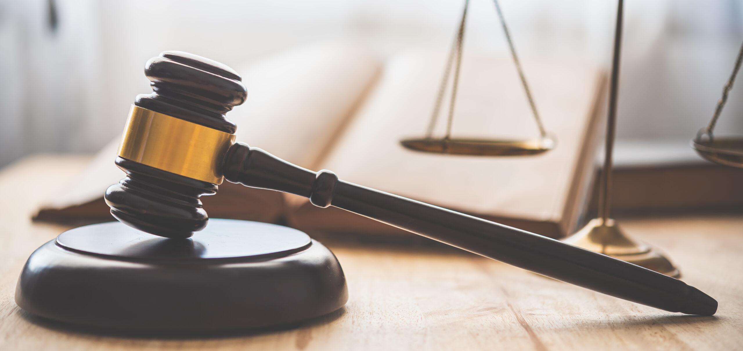 Gavel and scales of justice on a desk.