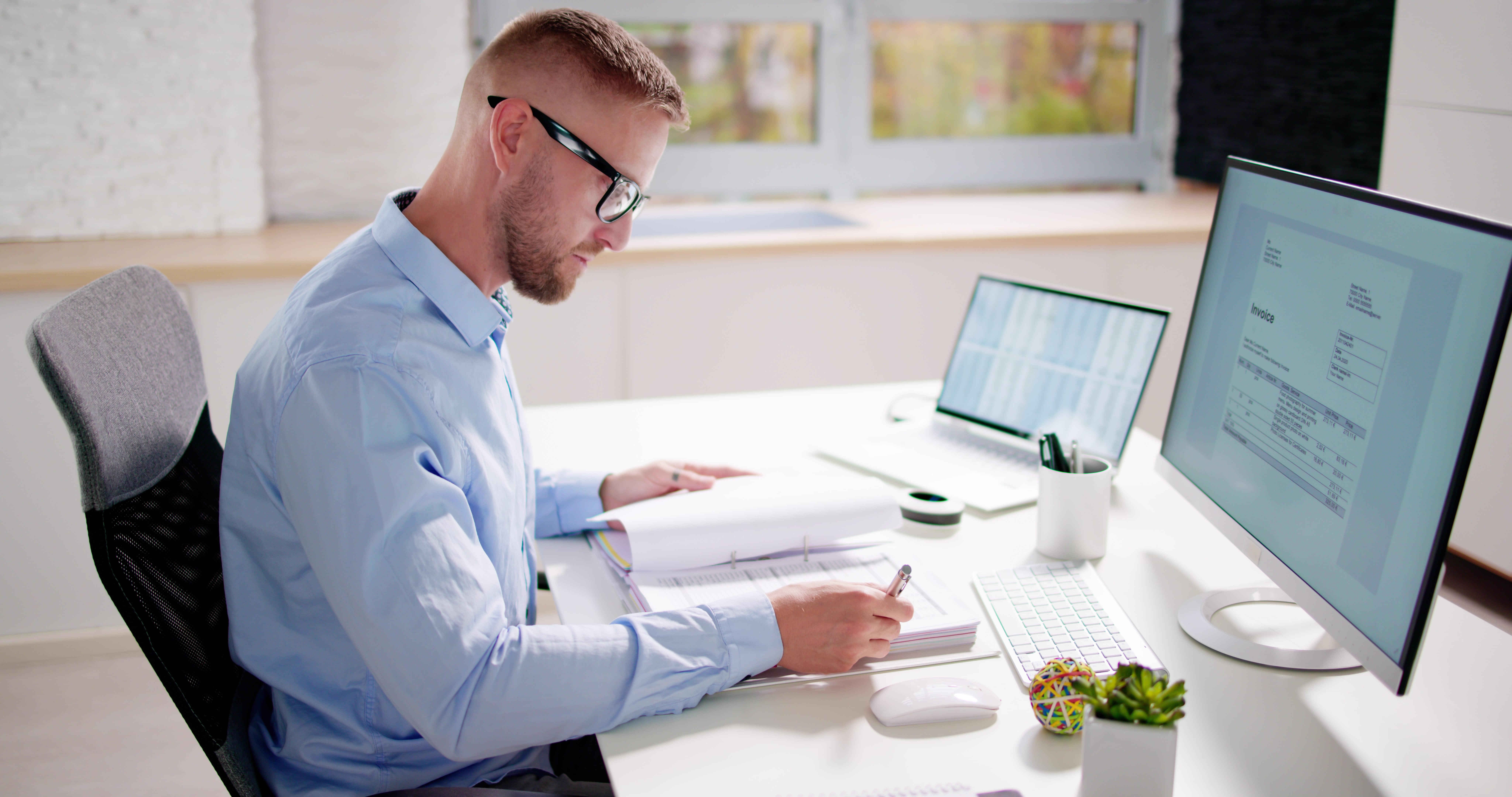 Man working at desk on paperwork.