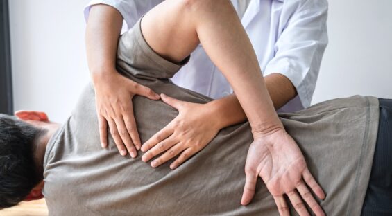 Chiropractor working on patient.