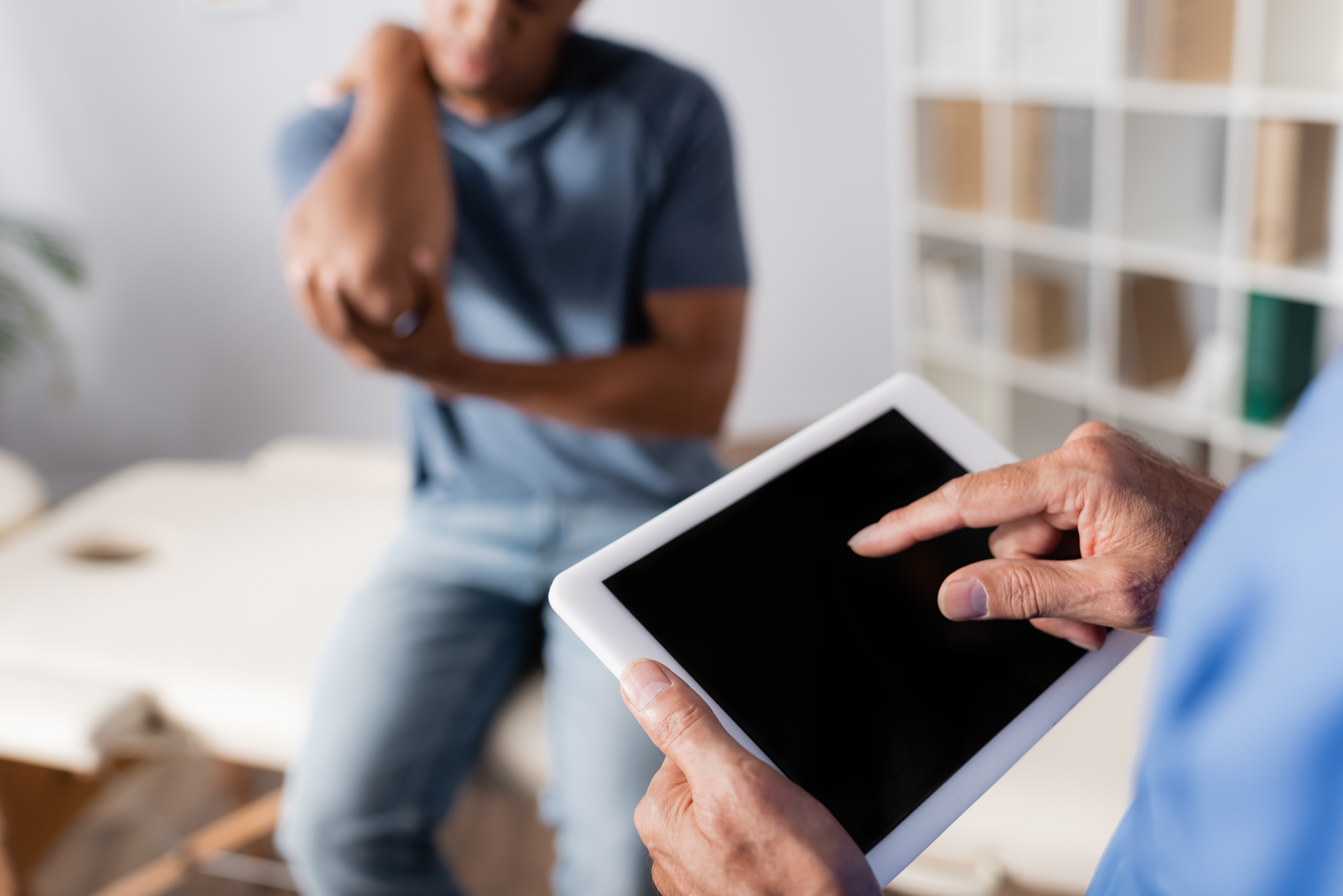 Doctor pointing at tablet.